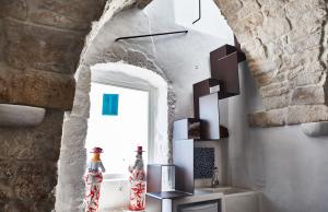 a room with a stone wall and a window at White Dream in Ostuni