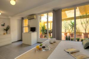 a living room with a couch and a large window at SingularStays Botanico 29 Rooms in Valencia