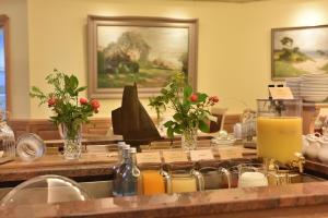 a counter with bottles of orange juice and other items at Romantik Hotel Fischerwiege in Ahrenshoop