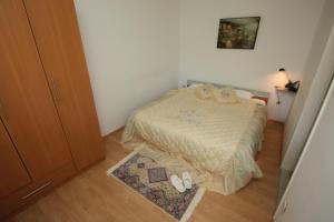 a small bedroom with a bed and a rug at Kuća za odmor- Simona in Punta Križa +5 photos