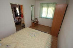 a bedroom with a large bed in a room at Kuća za odmor- Simona in Punta Križa