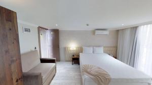 Postel nebo postele na pokoji v ubytování Patron Hotel