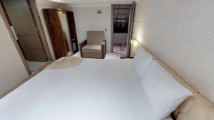 Postel nebo postele na pokoji v ubytování Patron Hotel