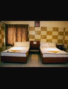 Кровать или кровати в номере Hotel Apple Sai Residency