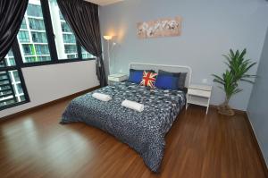 a bedroom with a bed in a room with wood floors at Kuching City Luxury Vivacity Suite A1 in Kuching