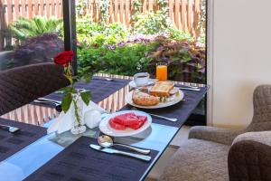 a table with a plate of breakfast food on it at Khuttar Apartment in Amman