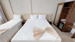 Postel nebo postele na pokoji v ubytování Patron Hotel