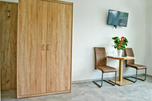 a door leading into a room with a table and two chairs at Pension Waldesruh in Linz +13 photos