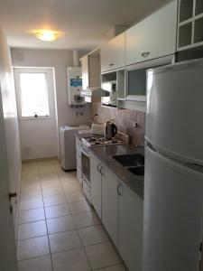 a kitchen with a sink and a refrigerator at Zelarrayan Centro in Bahía Blanca