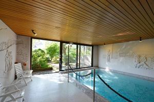 a house with a swimming pool in the middle at Hotel Sonne Eintracht KG Achern in Achern