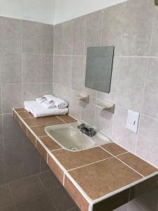 a bathroom with a sink and a mirror at Airport Sleepy Inn in Cancún +44 photos