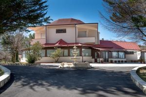 a building with a fountain in the middle of a road at Antico Resort Cerasella in Petralia Soprana