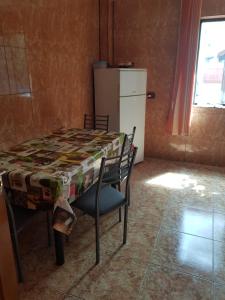 a kitchen with a table and chairs and a refrigerator at Vila Dan in Costinesti