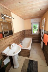a bathroom with a bath tub and a sink at Traumhafte Ferienwohnungen im Naturpark Zittauer Gebirge Haus Tanneck in Hain