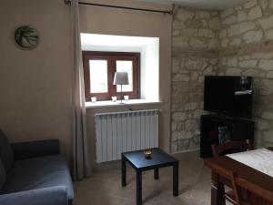 a living room with a couch and a table and a window at Pezzelelle in Roccamorice