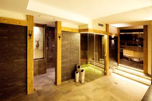 a bathroom with a shower with a glass door at Hotel Birkenhof in Saalbach Hinterglemm