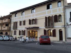 a red car parked in front of a building at Hotel '904 in Buggerru