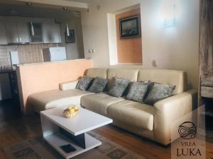 a living room with a couch and a table at Apartments Villa Luka in Sveti Stefan