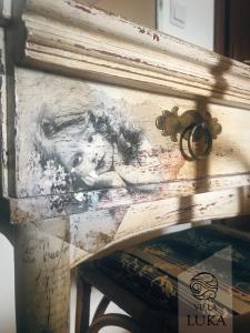 a painting of a horse on a wooden frame at Apartments Villa Luka in Sveti Stefan