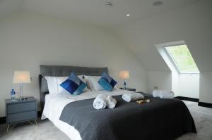 a bedroom with a large bed with two stuffed animals on it at Seascapes in Inch