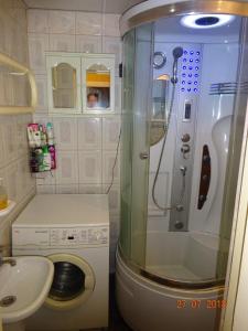 a bathroom with a shower and a toilet and a sink at Briedis un partneri in Cēsis