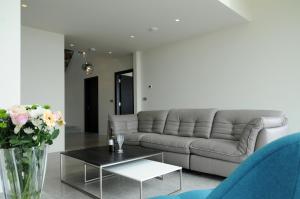 a living room with a couch and a table at Seascapes in Inch
