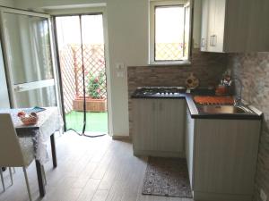 a kitchen with a sink and a stove at La Cycas Accommodation in Tropea