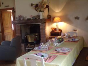 einen Tisch mit Weingläsern und einem Kamin in der Unterkunft Gite Forestier Gentil in Chanteloup-les-Bois