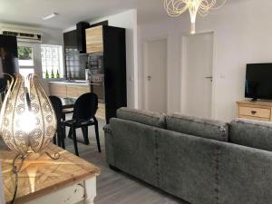 a living room with a couch and a table at Azores Calheta Inn Apartment T3 in Ponta Delgada