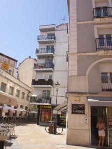 a woman standing in the doorway of a building at Jimena in Burgos