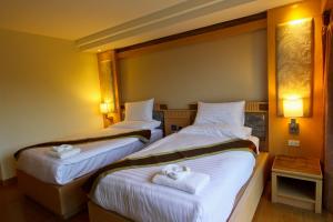 Ένα ή περισσότερα κρεβάτια σε δωμάτιο στο Kitlada Hotel Udonthani