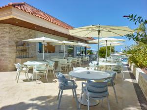 a patio with tables and chairs and umbrellas at Hotel Quinta do Lago in Quinta do Lago