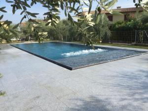 a swimming pool in a yard at Hotel La Pergola in Moniga