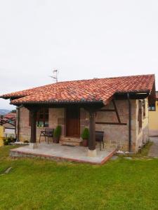 a small stone house with a patio and a roof at Casa Collao 24 in Sierra