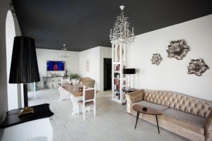 a living room with a couch and a table at Elia Vama Veche (Adults Only) in Vama Veche