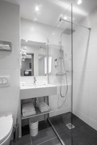 a bathroom with a shower and a sink at Hotel Paris Italie in Paris
