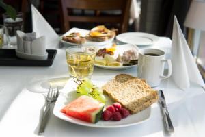 a table with plates of breakfast foods and a cup of coffee at Glomfjord Hotel in Glomfjord