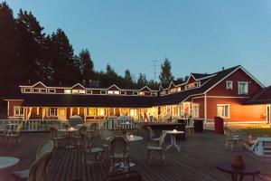 a building with chairs and tables on a deck at Boutique hotel Sawohouse in Kuopio