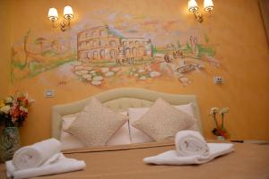 罗马Rome Innitaly Affittacamere o GuestHouse的卧室里有一张床，墙上挂着一幅画