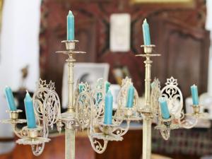 a group of chandeliers with blue candles on them at Casa Memoriala George Stephanescu in Căpăţîneni-Ungureni