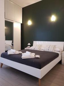een slaapkamer met een bed met handdoeken erop bij Milano Navigli Apartment - Via Savona in Milaan