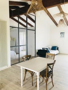 a dining room with a white table and chairs at Castel Apartment in Castellamonte +55 photos