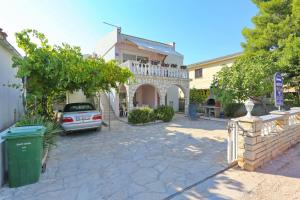 a car is parked in front of a house at Villa Neyla in Vir