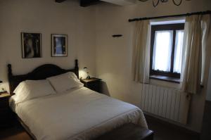 a bedroom with a white bed and a window at Alacran Home in Benasque +85 photos
