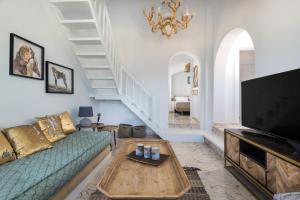 a living room with a couch and a tv at Summer Lovers Villa in Akrotiri