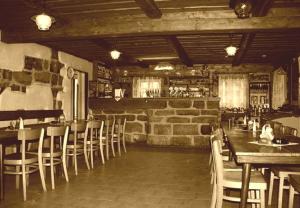 an old photo of a restaurant with tables and chairs at Dřevěnka in Provodín