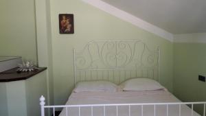 a bed with a white headboard in a bedroom at Lavanda in Torre del Lago Puccini