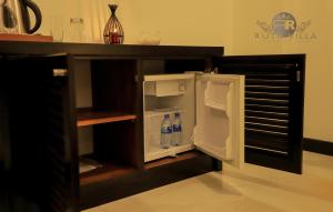 an open refrigerator with two bottles of water in it at Ruth Villa in Negombo