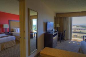 a hotel room with a bed and a tv at Ramada by Wyndham Phoenix Midtown in Phoenix