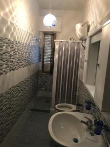 a bathroom with a sink and a toilet in it at Residence Lamezia Golfo in SantʼEufemia Lamezia